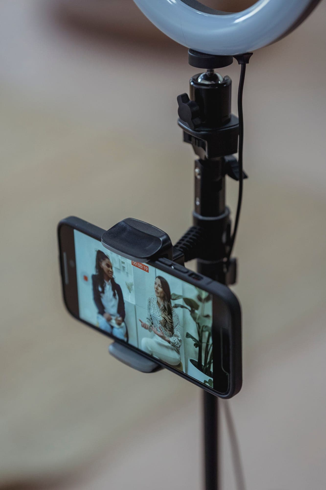 A smartphone on a stand recording a video call