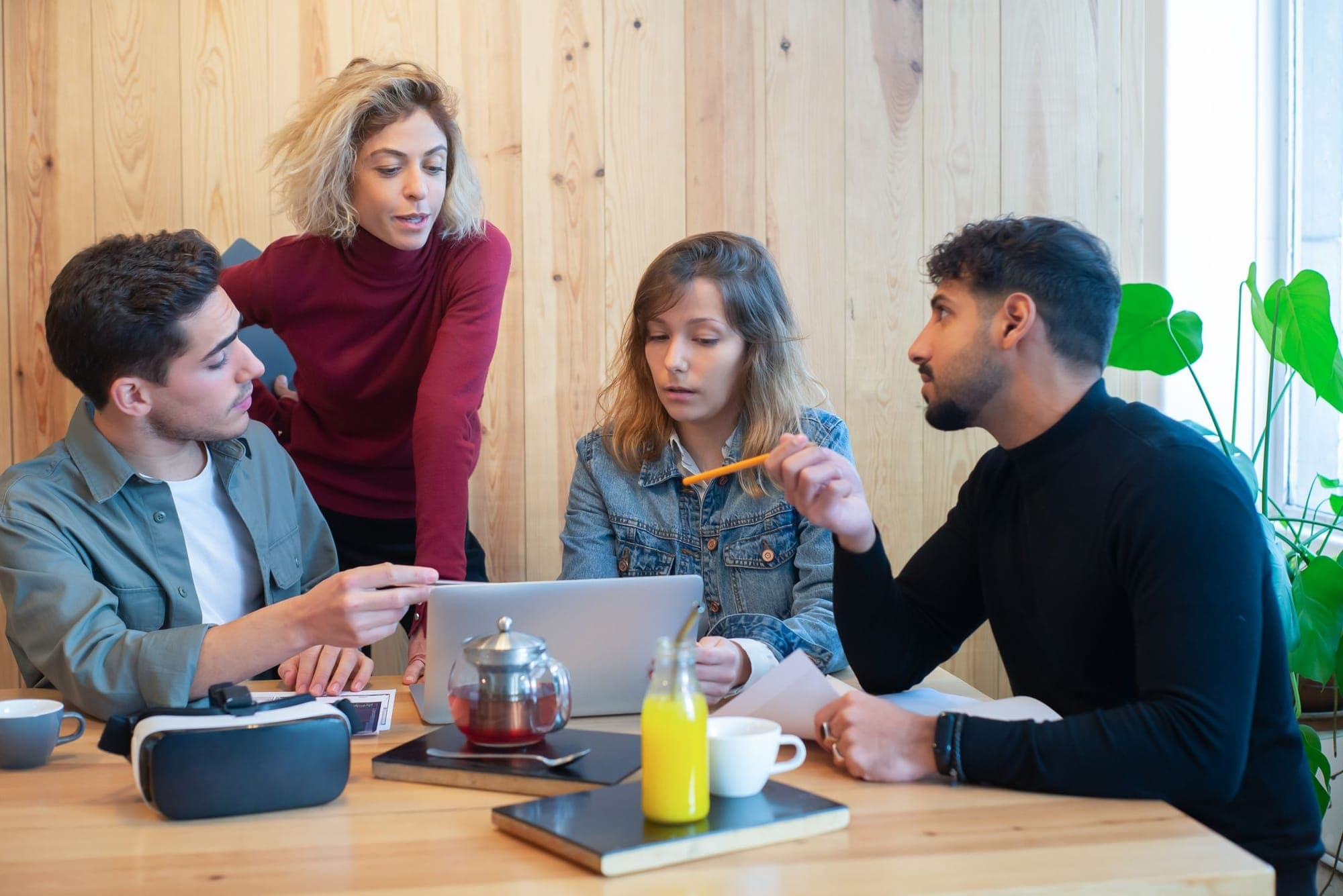 Four colleagues planning together around a table